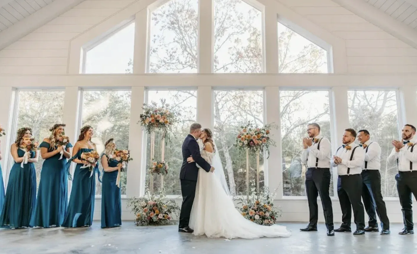 A couple kisses at their wedding ceremony at The Black Oak in Sulphur Springs, Texas